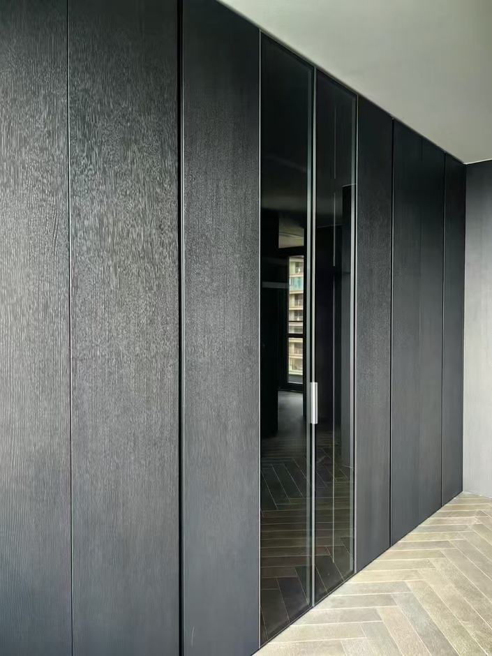 Black-oak veneer wall with glazed pivot
